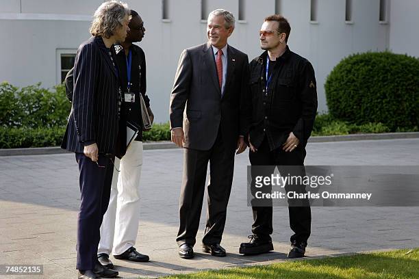 President George W. Bush shares a laugh with Irish environmental activist and U2 lead singer Bono and Irish political activist Bob Geldof and...