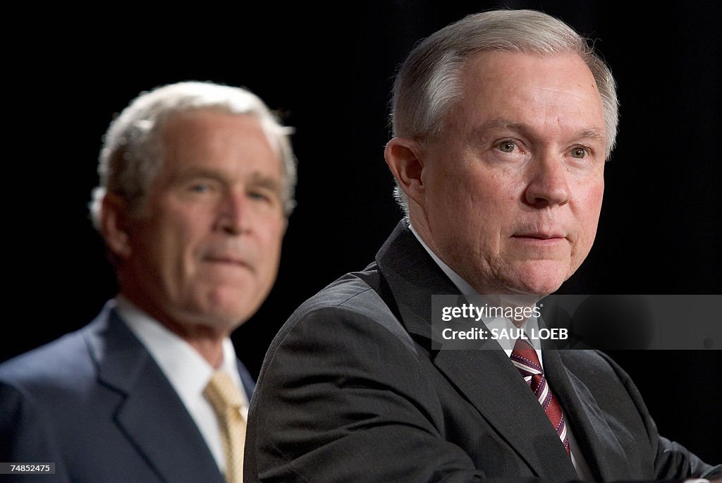 US President George W. Bush (L) listens...