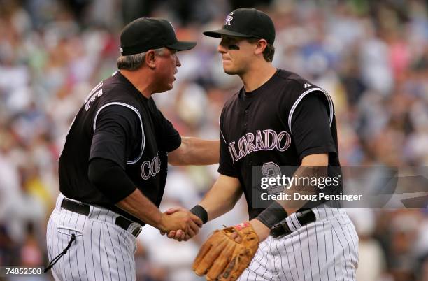 Troy Tulowitzki of the Colorado Rockies is congratulated by manager Clint Hurdle as he leaves the field after they swept the series with the New York...