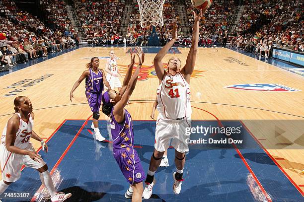 Erika Desouza of the Connecticut Sun shoots a layup against Jessica Moore of the Los Angeles Sparks during a WNBA game at the Mohegan Sun Arena on...