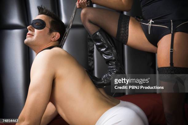 dominatrix with foot on man's back - cool man leather bildbanksfoton och bilder