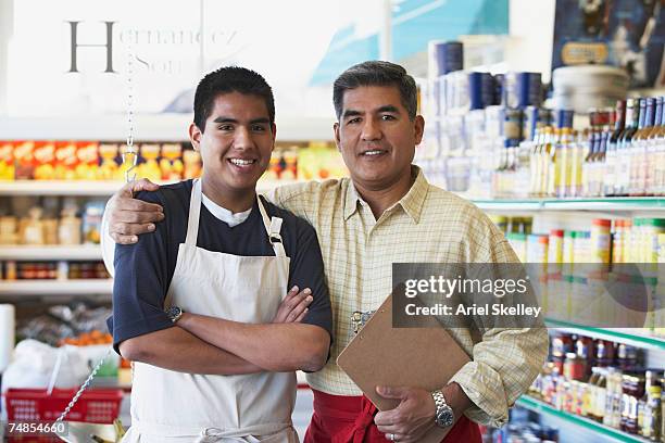 hispanic father and son in family owned bodega - father son business bildbanksfoton och bilder