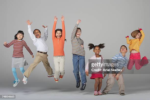 multi-ethnic children jumping - indian boy standing stock pictures, royalty-free photos & images