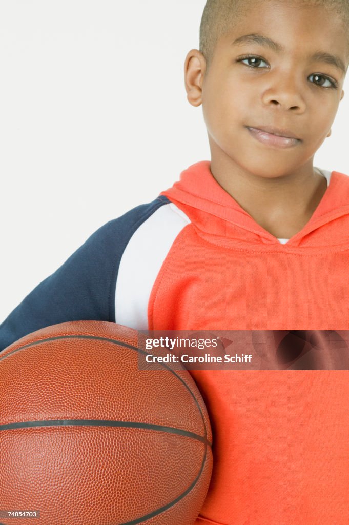 African boy holding basketball