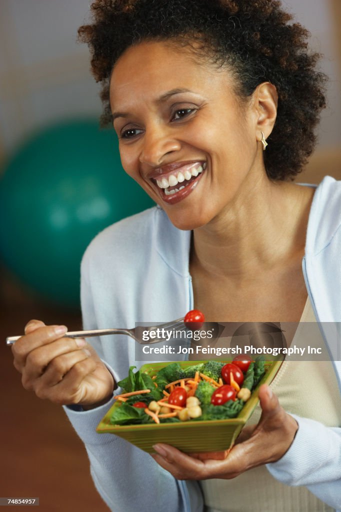 African woman eating salad