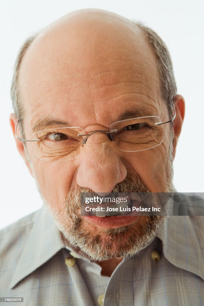 Close up of senior man making a face