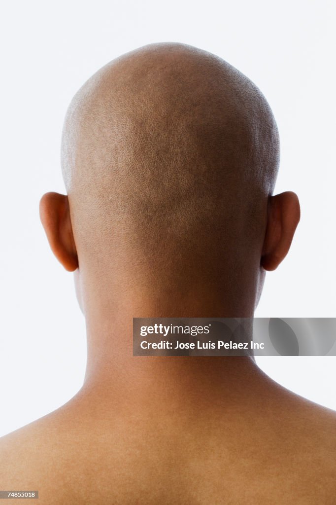 Rear view of bald Hispanic man