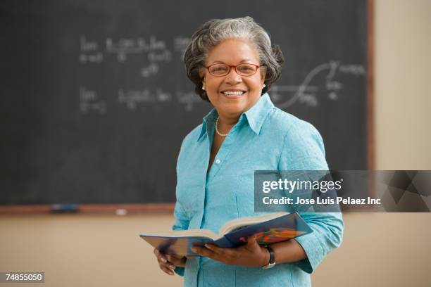 senior african woman in classroom - teacher portrait stock pictures, royalty-free photos & images