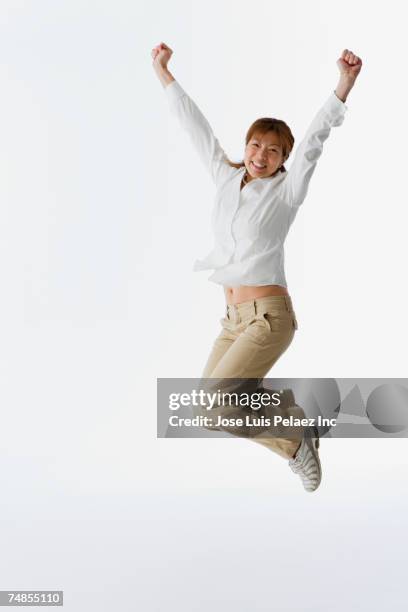 asian woman jumping - 応援　日本人 ストックフォトと画像