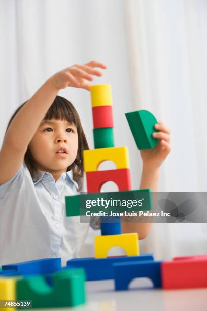 asian girl playing with blocks - wood block stacking stock pictures, royalty-free photos & images