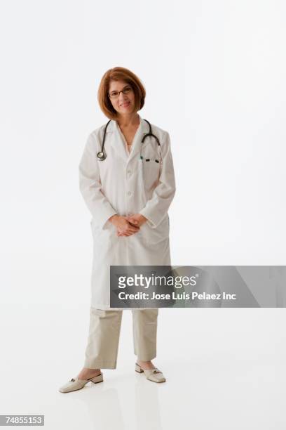 irish female doctor with hands clasped - doctor full length stock pictures, royalty-free photos & images