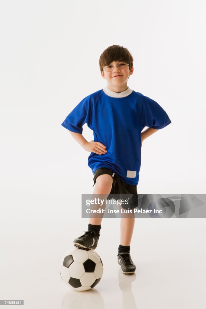 Greek boy with foot on soccer ball