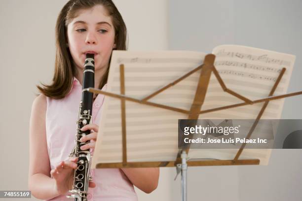 irish girl playing clarinet - klarinette stock-fotos und bilder