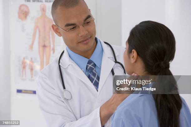 male doctor examining patient - stethoscope around neck stock pictures, royalty-free photos & images