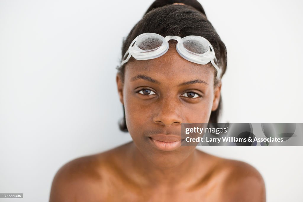 African girl wearing goggles on head