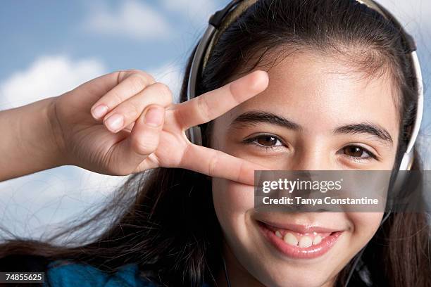 hispanic girl making peace sign with hand - make music day stock pictures, royalty-free photos & images