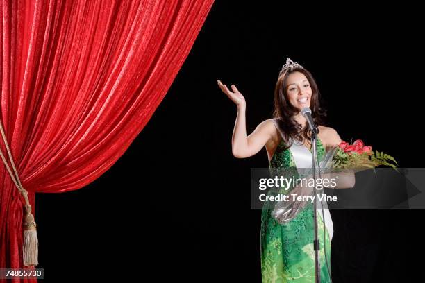 hispanic beauty pageant winner waving on stage - prom queen stock pictures, royalty-free photos & images