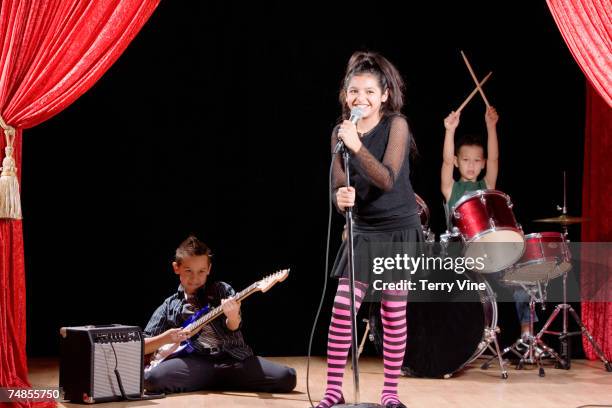 multi-ethnic children performing in band - child rock band stock-fotos und bilder