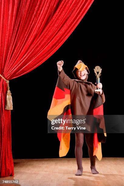 boy in turkey costume holding trophy - animal win stockfoto's en -beelden