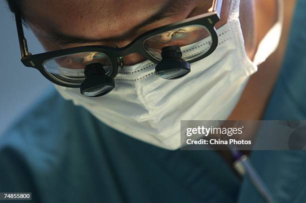 Doctor does an operation for a child suffering from cleft lip and palate, at the Xian Jingxi Hospital during registration for treatment jointly...