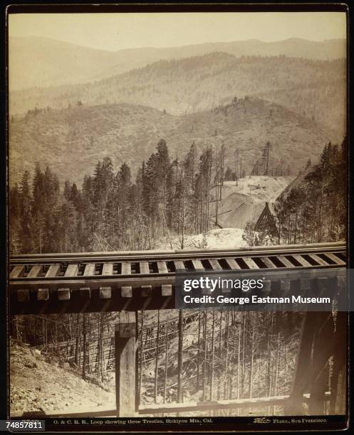 View of a portion of the then-underconstruction Oregon and California Railroad as ir bridges a gap in the Siskiyou Montains, northern California,...