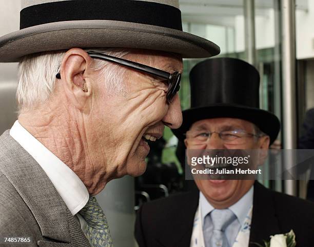 Former jockey Lester Piggott is greeted by former jockey and tv pundit Willie Carson as he arrives at Ascot Racecourse on the fourth day of The Royal...