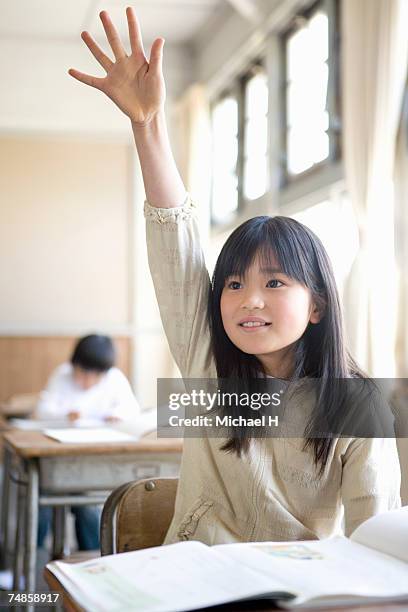 girl (6-7) raising hand in school classroom - asian kid raising hand bildbanksfoton och bilder