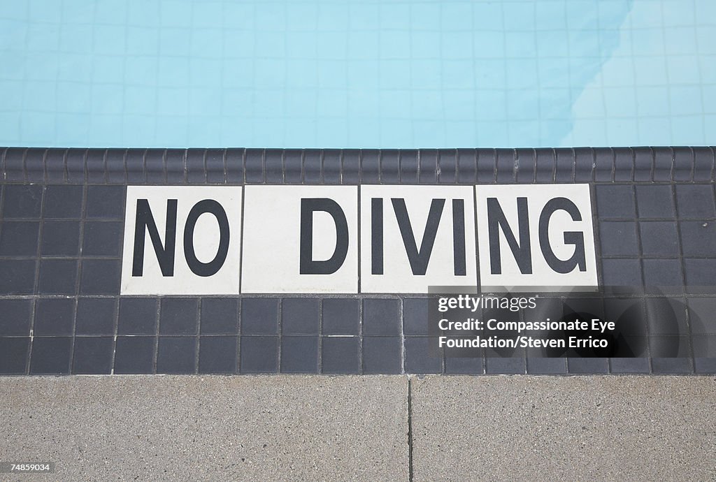 No Diving sign on floor at swimming pool