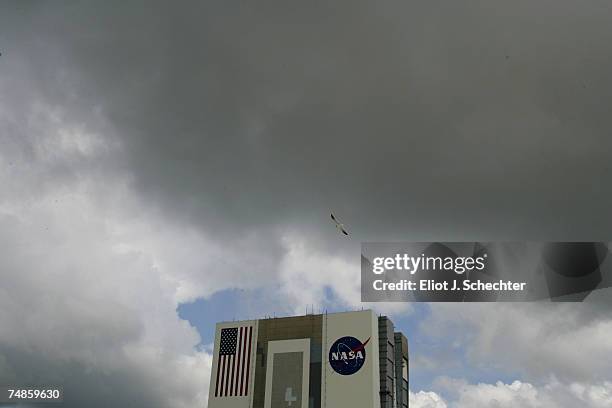Clouds move in near the Vehicle Assembly Building as a loan seagull glides by before the first landing attempt by the Space Shuttle Atlantis June 22,...