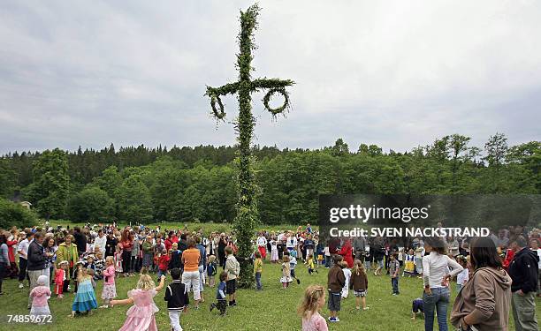 Swedes dance as they celebrate the "Midsommar evening" 22 June 2007 in the Tyreso Castle, located 27 kms south-east of Stockholm. The midsummer marks...
