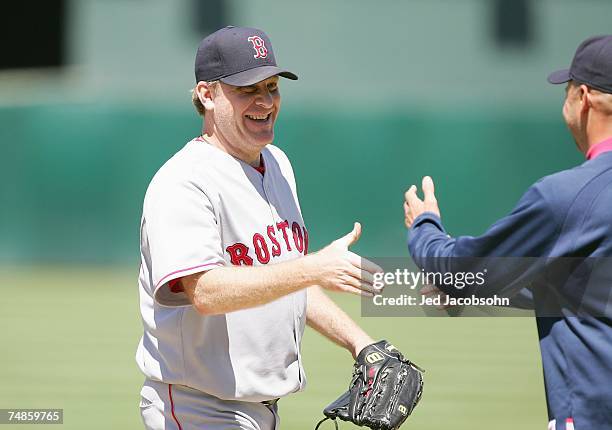 Curt Schilling of the Boston Red Sox shakes hands with manager Terry Francona after defeating the Oakland Athletics with a one hitter during a Major...