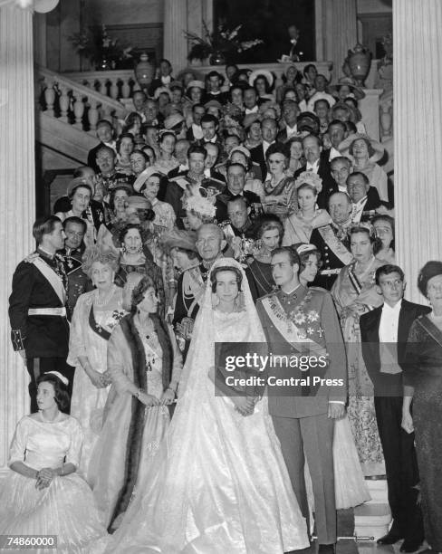 Prince Juan Carlos of Spain and Princess Sophia of Greece pose with their guests on the steps of the royal palace in Athens, after their wedding...