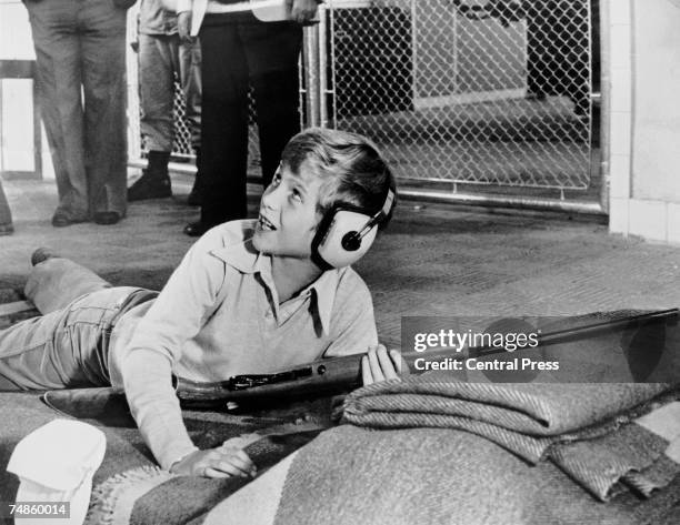 Prince Felipe of Spain scores a bullseye at the firing range during a visit to the military academy in Madrid, 26th October 1978.