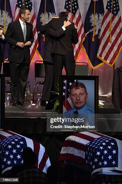 Mayor Joseph P. Riley and Charleston, South Carolina Chief Russell Thomas, Jr. Embrace during a memorial service at the North Charleston Coliseum for...