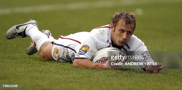 Leeds, UNITED KINGDOM: Britain's Rob Burrow goes over for a try against France during the Frontline rugby league test match at Headingley stadium in...