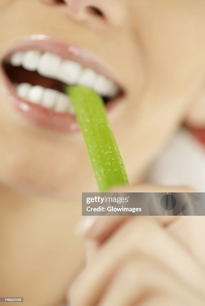 Close-up of a young woman eating an asparagus