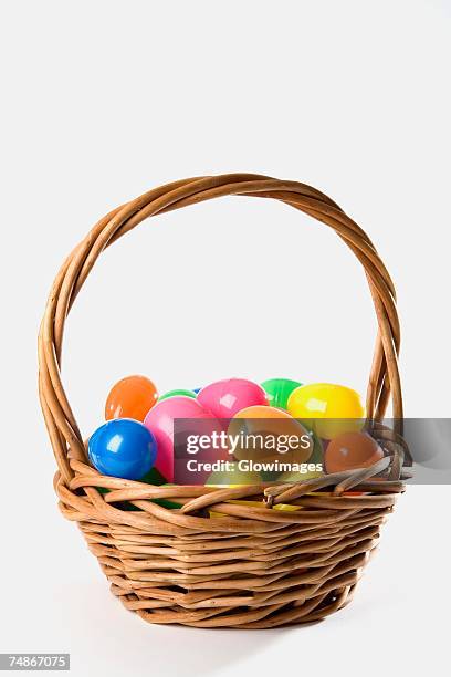 close-up of toy eggs in a basket - eggs basket stock pictures, royalty-free photos & images