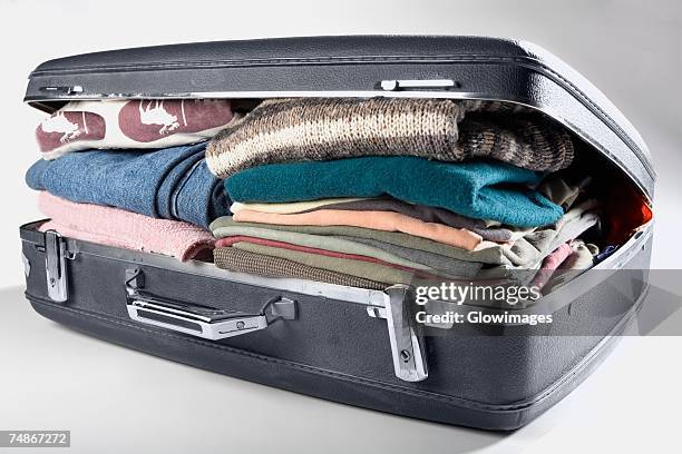 close-up of a suitcase full of clothes - suitcase close stock-fotos und bilder