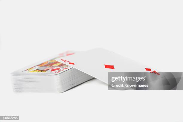 close-up of the ace of diamonds on a stack of playing cards - jeux photos et images de collection