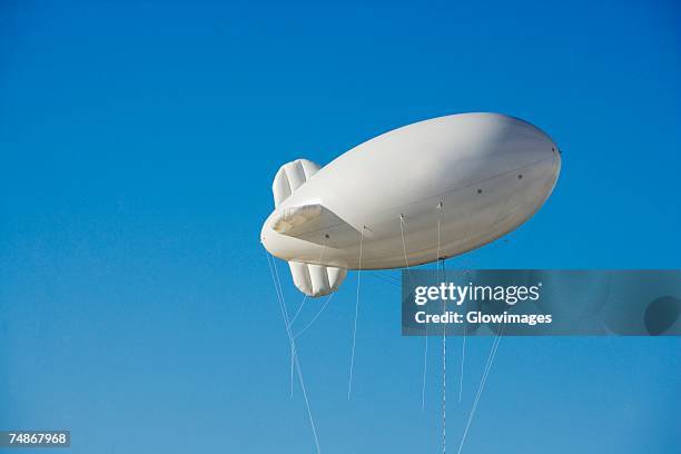 low angle view of a blimp in the sky - luftschiff stock-fotos und bilder