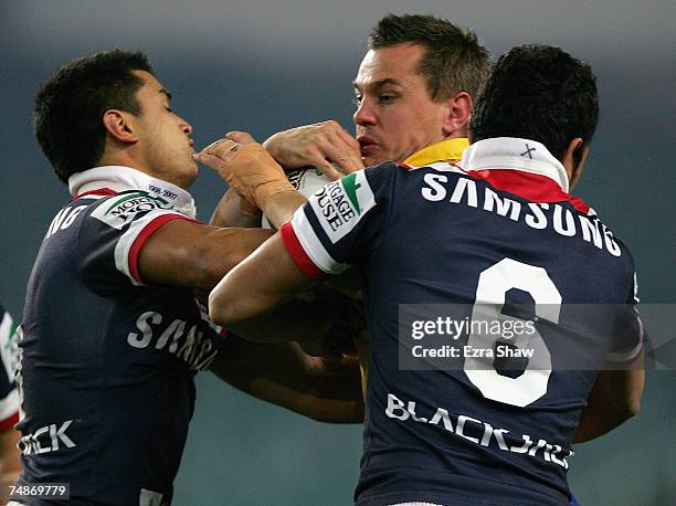 Chad Robinson of the Eels is tackled by Craig Wing and Setaimata Sa of the Roosters during the round 15 NRL match between the Sydney Roosters and the...