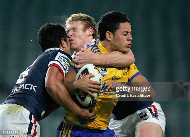 Setaimata Sa and Joel Monaghan of the Roosters collide heads while they tackled Jarryd Hayne of the Eels during the round 15 NRL match between the...