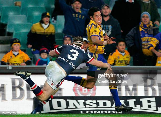 Jarryd Hayne of the Eels outruns Joel Monaghan of the Roosters to score a try during the round 15 NRL match between the Sydney Roosters and the...