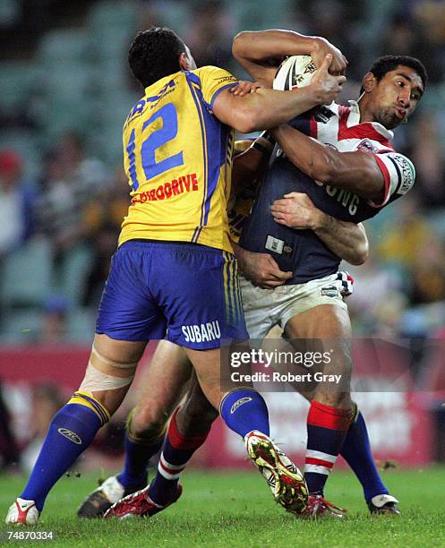 Sia Soliola of the Roosters is tackled during the round 15 NRL match between the Sydney Roosters and the Parramatta Eels at Aussie Stadium on June...