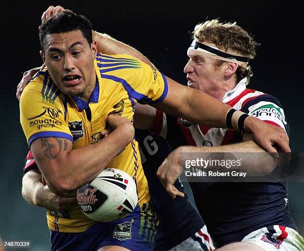 Feleti Mateo of the Eels loses the ball while being tackled by Joel Monaghan of the Roosters during the round 15 NRL match between the Sydney...