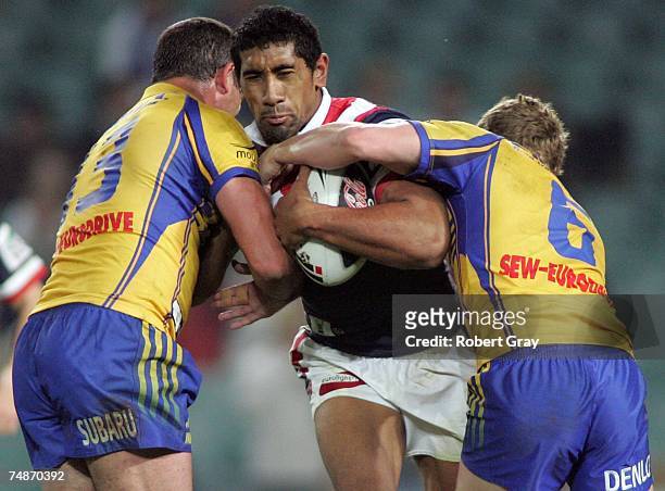 Sia Soliola of the Roosters is tackled during the round 15 NRL match between the Sydney Roosters and the Parramatta Eels at Aussie Stadium on June...