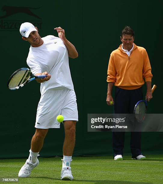 Andy Roddick of the USA hits a forehand as his coach Jimmy Connors looks on while practicing during previews for the Wimbledon Lawn Tennis...