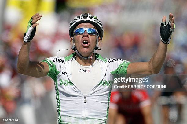 Schwarzsee, SWITZERLAND: Colombian Rigoberto Uran raises his arms in victory a he crosses the finish line to win in the 71st Tour de Suisse UCI...