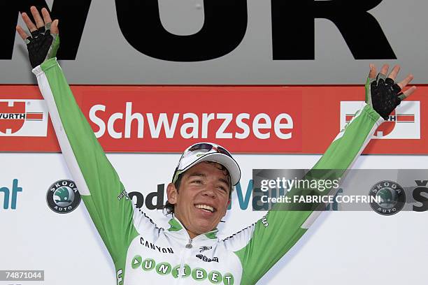 Schwarzsee, SWITZERLAND: Colombian rider Rigoberto Uran raises his arms on the podium after winning the 71st Tour de Suisse UCI protour cycling...