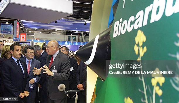 French President Nicolas Sarkozy with at his side Environment minister Jean-Louis Borloo listens to the explanations of French company Safran...